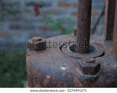 Closeup of screws of old rusty water pump Royalty-Free Stock Photo #2274491271
