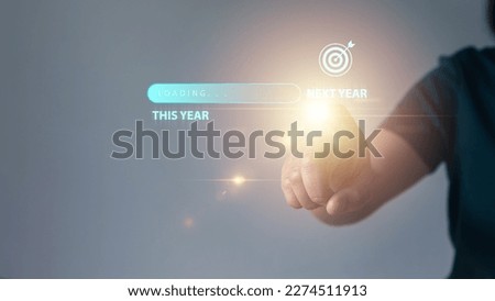 Businessman touching virtual screen this year target concept, new year planning, next year, loading, success, dart board, start up, action plan and strategy in new business. Royalty-Free Stock Photo #2274511913