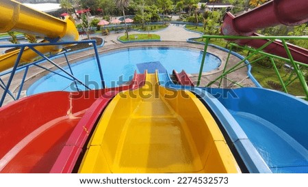 The view from the top of the colorful water slide Royalty-Free Stock Photo #2274532573