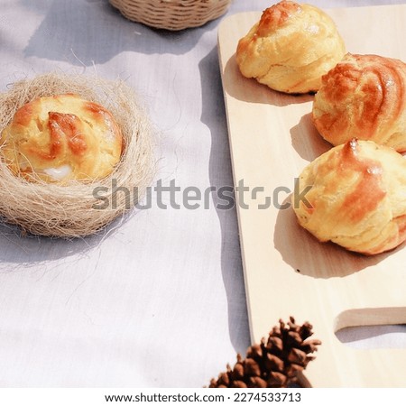 Picture of Cakes with Pine and plate decoration. The name is cake is Cream puff or sus