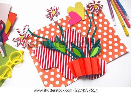 Child creating homemade greeting card. Paper vase with bouquets of flowers, gift for Mothers day, Birthday or Valentines day . Arts crafts concept. Preshool crafts
 Royalty-Free Stock Photo #2274537617