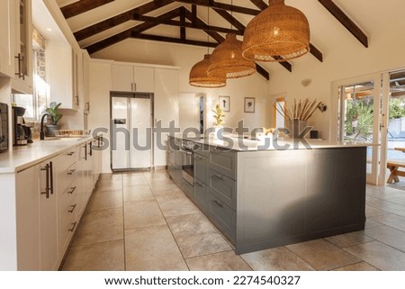 General view of modern kitchen with countertop and kitchen equipment. House interior and design concept.