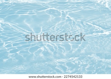 Defocus blurred transparent blue colored clear calm water surface texture with splashes and bubbles. Trendy abstract nature background. Water waves in sunlight with copy space. Blue watercolor shining Royalty-Free Stock Photo #2274542133