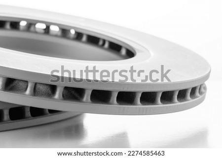 close-up brake discs on a white background, spare parts for routine maintenance of the machine, brake system and its parts. High quality photo