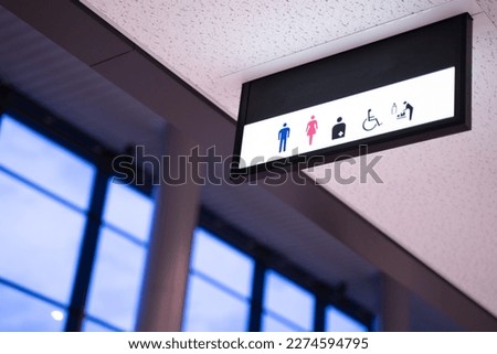Toilet sign on the ceiling of the entrance to the bathroom Toilet sign concept. Icons set. Male and female toilet sign for restroom.
