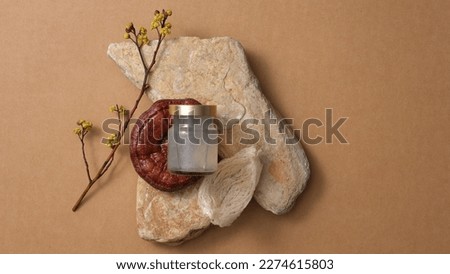 Scene mockup for product with bird's nest water bottle and red reishi mushroom (Ganoderma lucidum) put on stones, on brown background. A luxury food from nature. Top view, flat lay. Royalty-Free Stock Photo #2274615803
