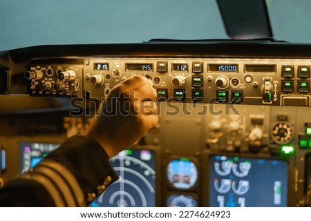 A man is studying to be a pilot in a flight simulator. Close-up of male hands on the control panel of an aircraft. Royalty-Free Stock Photo #2274624923
