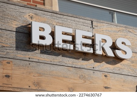 text pub beers sign on facade wall front building cafe bar entrance in street