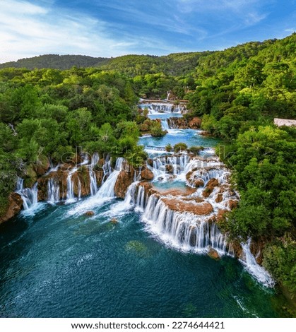Krka, Croatia - Aerial view of the beautiful Krka Waterfalls in Krka National Park on a bright summer morning with green foliage, turquoise water and blue sky Royalty-Free Stock Photo #2274644421