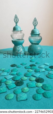 Turquoise blue ceramic or glass antiques andor vases on a turquoise background