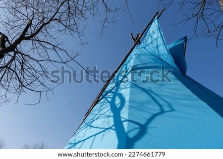 blue wigwam set up in a garden, Indian folklore, early spring

