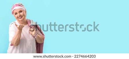 Stylish elderly woman on light blue background with space for text