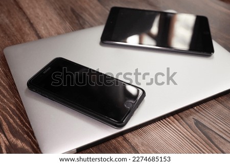 Devices with blank screens on wooden background, top view. 