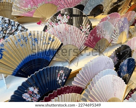 Colorful fans of traditional Japanese crafts lined up.