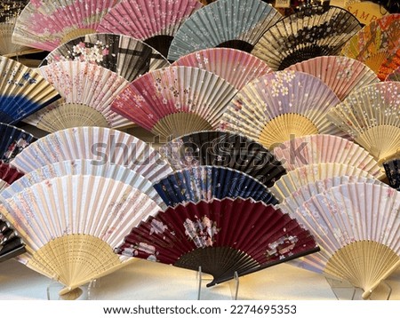 Colorful fans of traditional Japanese crafts lined up.