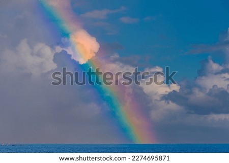 Beautiful landscape with turquoise sea and rainbow at sunset
