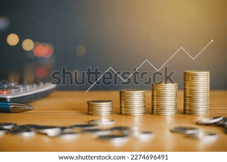 Stack of money coin on wooden desk with up arrow. Financial Concept. 