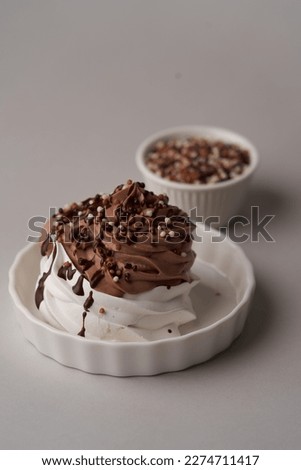 Cupcake with meringue and chocolate. Whipped cream mini cake