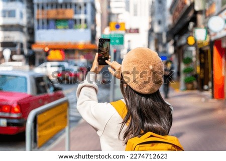 Young woman traveler walking in the Mong Kok in Hong Kong, Mong Kok is one of the major shopping areas in Hong Kong Royalty-Free Stock Photo #2274712623