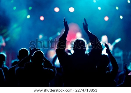 Fans and audience enjoy live music concert with colorful blurry bokeh background Royalty-Free Stock Photo #2274713851
