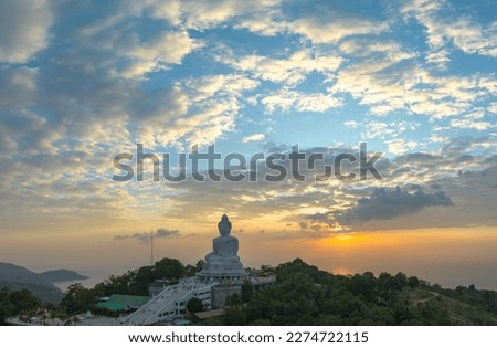 aerial view Phuket big Buddha in beautiful sunset.
the sun shines through the clouds impact on ocean surface
The beauty of the statue fits perfectly with the charming nature.
cloud scape background.
