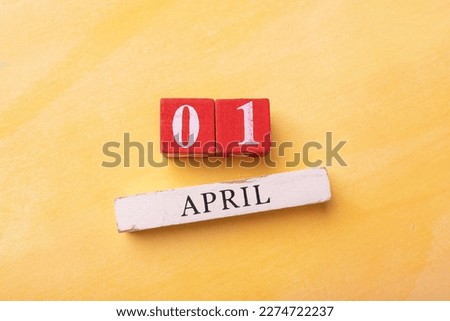 date April 1. Creative concept for April Fools' Day on the yellow background.