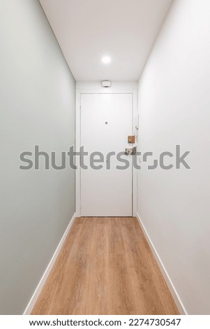 White corridor with entrances to a bright room and doors in an empty apartment before moving or after renovation. Concept of renovation and moving into compact new apartment. Copyspace Royalty-Free Stock Photo #2274730547