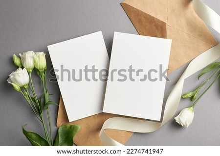 Blank wedding invitation card mockup with envelope and white flowers, front and back sides, mockup with copy space