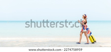 Summer vacations. Lifestyle  woman relax and chill on beach background.  Asia happy young people walking with bag travel suitcase luggage fashion dress.  Summer trips travel, copy space for banner