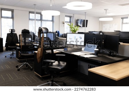 Empty open space office with desks, chairs and computers. Business, corporation and working in office concept. Royalty-Free Stock Photo #2274762283