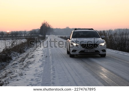 car during the sunset. polish nature arround, frost, snow and ice. Royalty-Free Stock Photo #2274767895