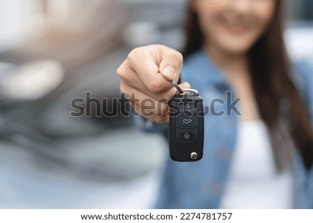 transportation rental automotive business concept. Close up hands of rental auto agent giving car remote key to client to travel sightseeing. Royalty-Free Stock Photo #2274781757