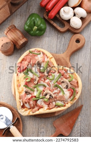 Pizza is a dish of Italian origin consisting of a usually round, flat base of leavened wheat-based dough topped with tomatoes, cheese, and often various other ingredients 