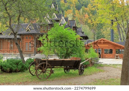 The photo was taken in the Ukrainian city of Yaremchey. The picture shows an old cart in the courtyard of the Carpathian wooden house.