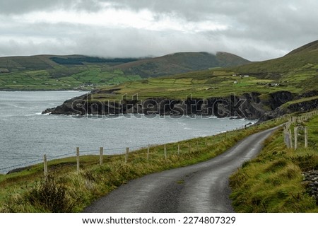 Rural road leading towards Bolus Head, part of the Bolus Barracks Loop hiking trail, Iveragh Peninsula, County Kerry, Ireland Royalty-Free Stock Photo #2274807329