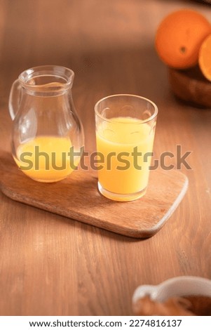 Still life of orange juice on a wooden board with space for advertising. Vertical view.