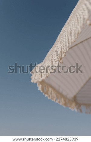 Minimal summer holidays vacation concept. Beach umbrella in front of blue sky