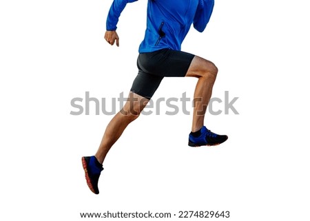 male runner in blue windbreaker and black tights running uphill, cut silhouette on white background, sports photo