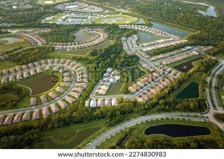 Aerial view of tightly located family houses in Florida closed suburban area. Real estate development in american suburbs Royalty-Free Stock Photo #2274830983