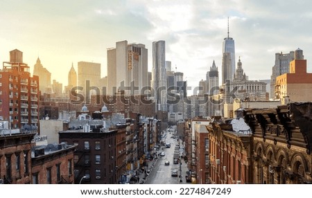 Overhead view of Madison Street in the Chinatown neighborhood of Manhattan with the downtown skyline buildings of New York City in the background Royalty-Free Stock Photo #2274847249