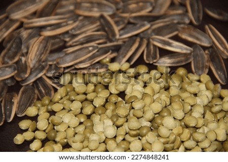 Scattered sunflower seeds and green peas. Backgrounds
