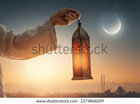 Ornamental Arabic lantern with burning candle glowing at night mosque background. Festive greeting card, invitation for Muslim holy month Ramadan Kareem. Royalty-Free Stock Photo #2274868209