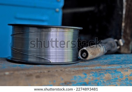 Photo of new welding wire spool on the wood Royalty-Free Stock Photo #2274893481