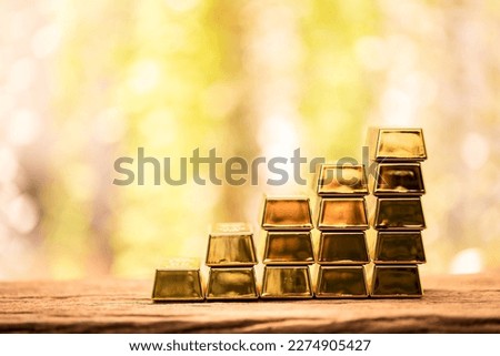 Stack gold bar with high value for invest put on the old wood on the morning sunlight in public park, Targeting of business to winner and success concept.