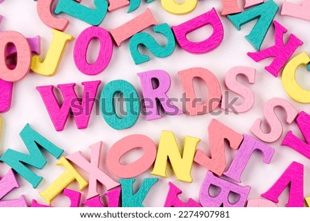 Words of wooden letters on a white background. Children's creativity.