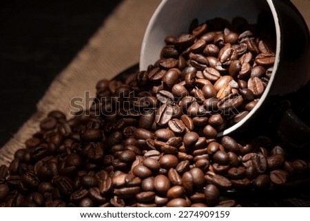 Coffee beans close-up, illuminated by a beam of sunlight. Close-up of coffee beans with focus on the center.