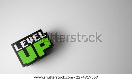 Word: ''Level up'' cube with a with background and space for text Royalty-Free Stock Photo #2274919359
