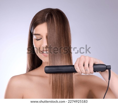 Hair straightener, face and beauty of woman in studio isolated on a gray background. Eyes closed, haircare and happy female model with flat iron product for salon treatment, balayage and hairstyle. Royalty-Free Stock Photo #2274925183