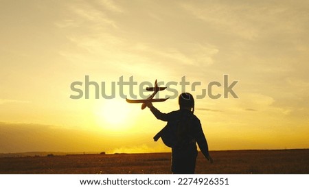 child girl aircraft pilot. kid child wants be able fly. children run with airplane sunset. childhood dream of an airplane pilot. kid superhero. girl daughter child runs with a toy plane in her hands.