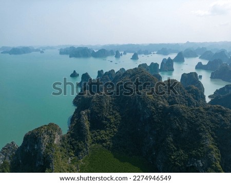Aerial view floating fishing village and rock island, Ha Long Bay, Vietnam, Southeast Asia. UNESCO World Heritage Site. Junk boat cruise to Ha Long Bay. Popular landmark, famous destination of Vietnam Royalty-Free Stock Photo #2274946549